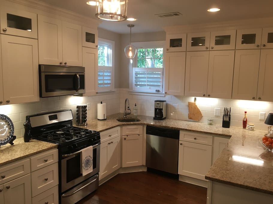 Full gourmet kitchen with bar and three stools.