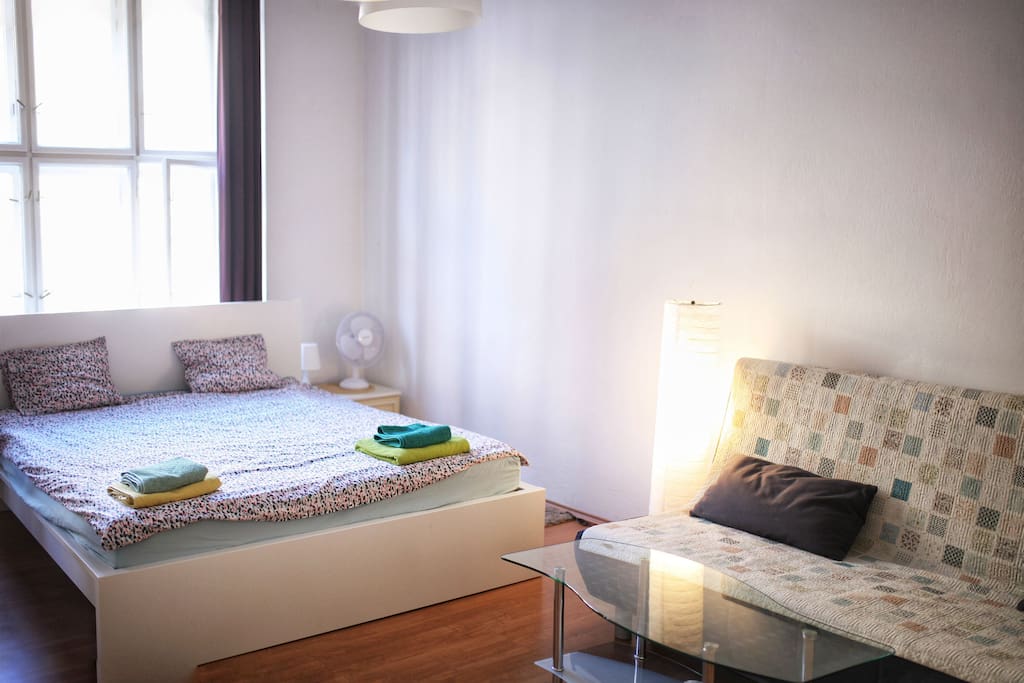 spacious fancy bedroom with a private bathroom and a sofa
