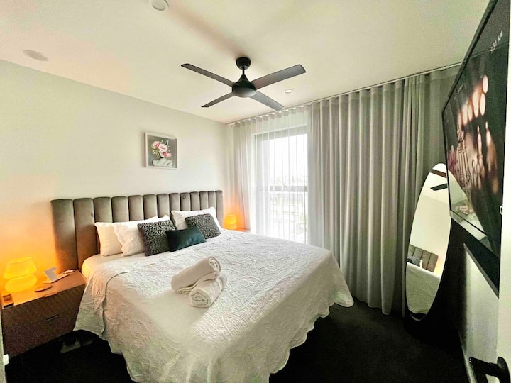 Dormitorio con cortinas oscuras y un cómodo colchón de tamaño amable.