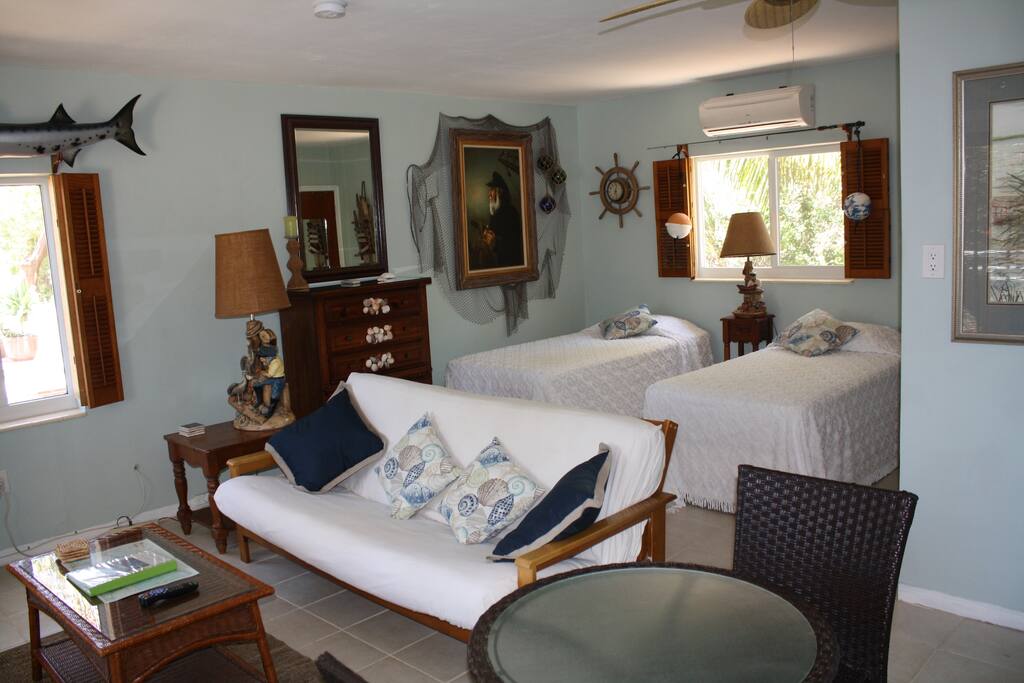 Two single beds, sofa with coffee table and small dining table for two