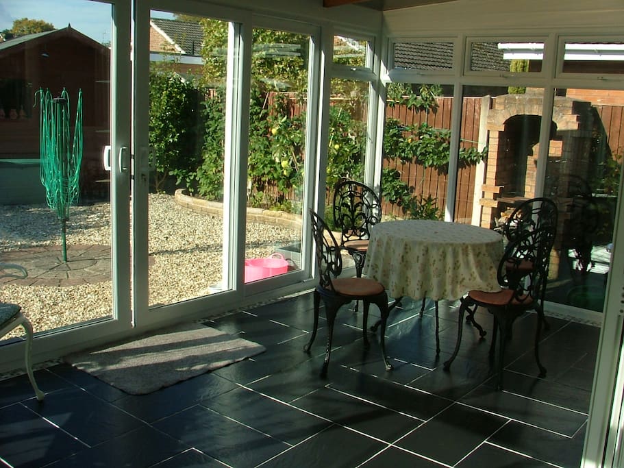 Open and warm conservatory, with extra eating space, usable throughout the year thanks to under floor heating.