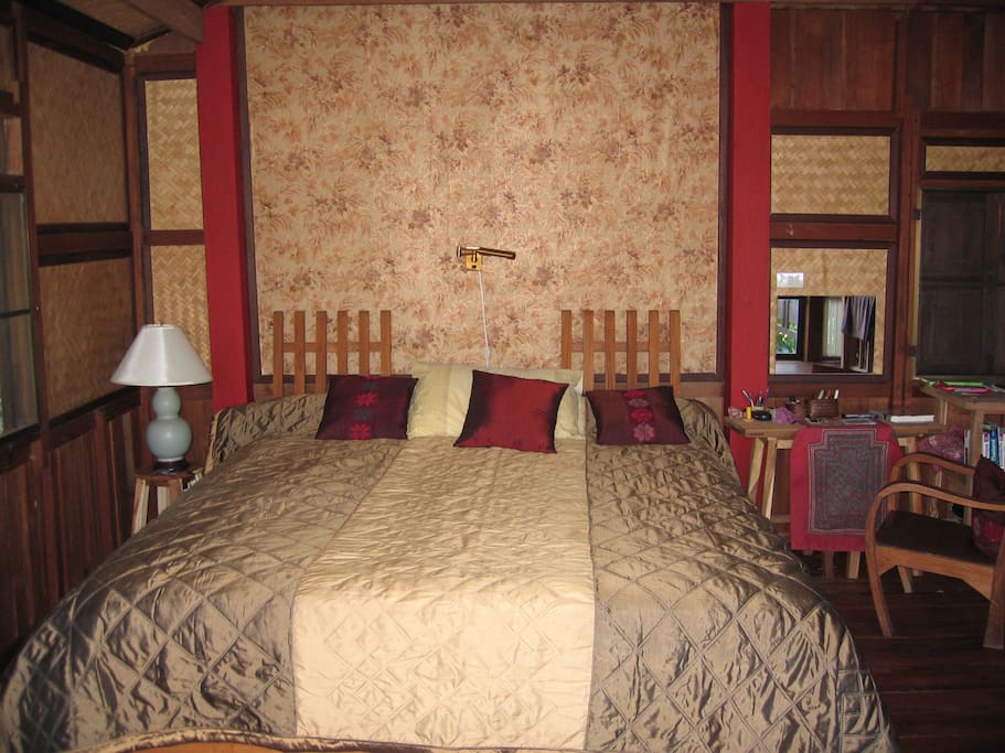 bedroom with wooden floor and writing desk