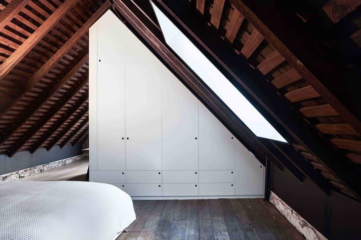 Loft bedroom space with full height storage + city views