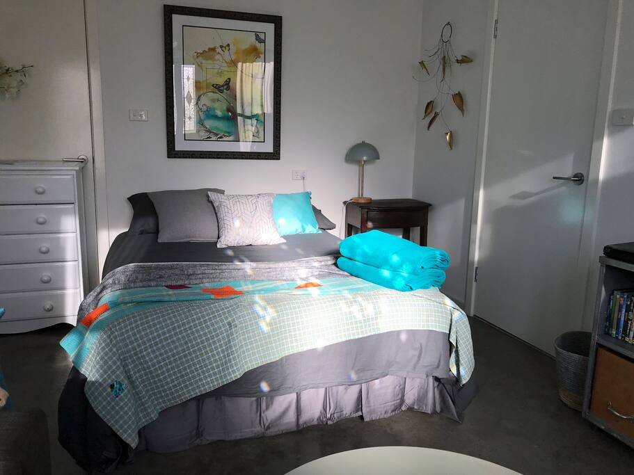 A tranquil, quiet and private bedroom/living room studio featuring stunning art works and sculptures on the gallery like walls.