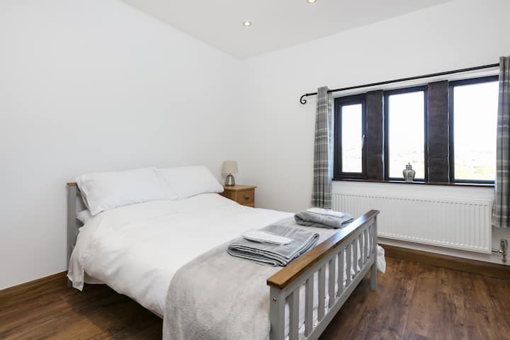 Bedroom 1 - double bed with walk-in wardrobe and ample drawer storage.