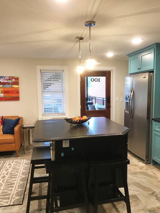 Custom granite topped island. 4 bar stools. Ample room to enjoy a home cooked meal or your favorite carry out from one of our local restaurants.