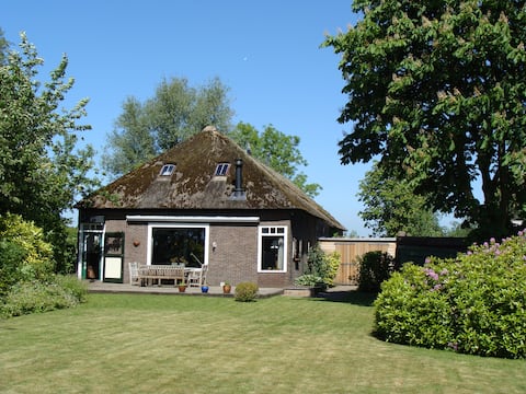 BIG OLD FARM WITH A THATCHED ROOF