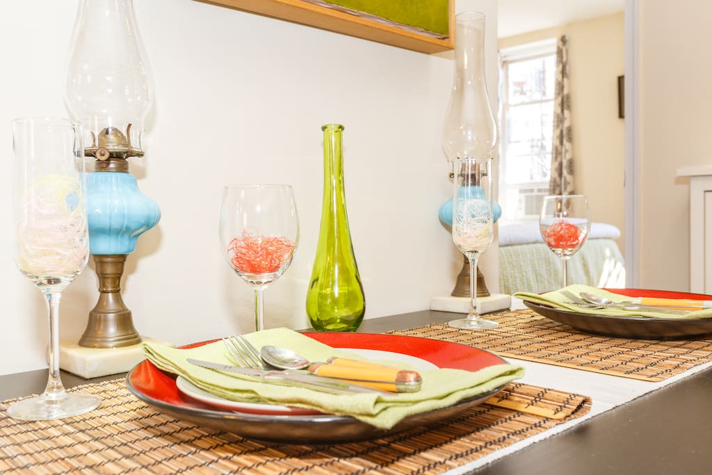 The kitchen seating area is very small, darling, and charming.