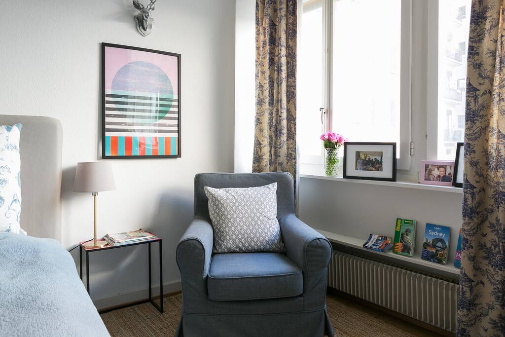 The reading corner harbors a comfortable armed chair to dive into a good book!