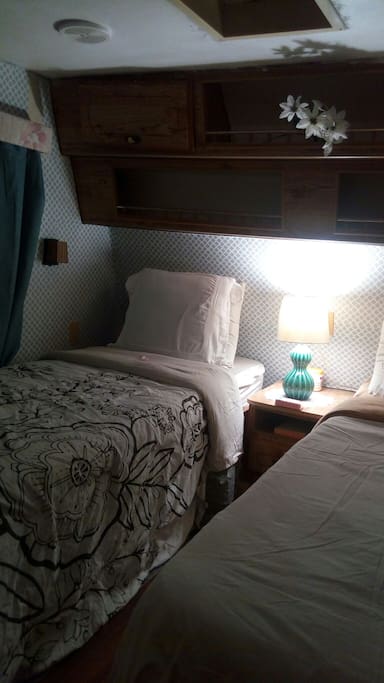 Updated wallpaper and beds with over head lighting.