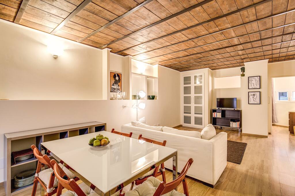 Living room with dining table and sofa bed.