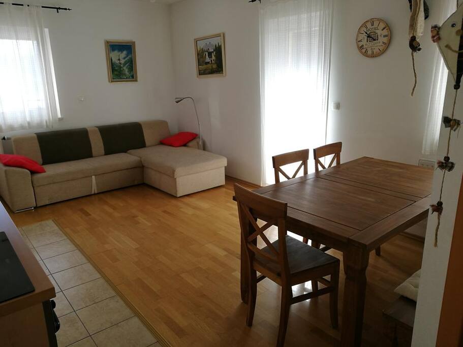 Living room with sofa bed and dining area.