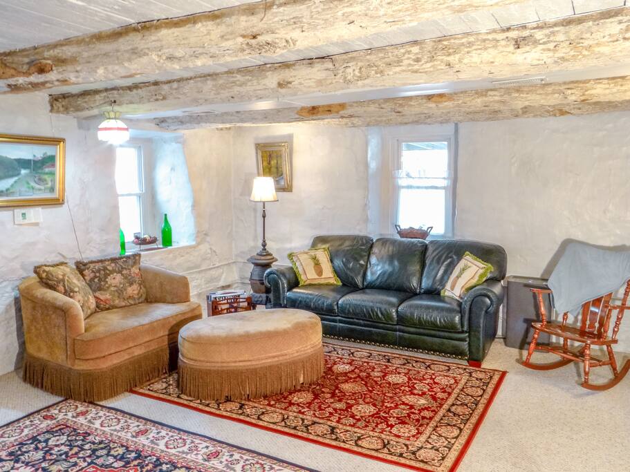 Overstuffed couches highlight the massive stone walls and whitewashed hewn logs, making a wonderful place talk and share wine.