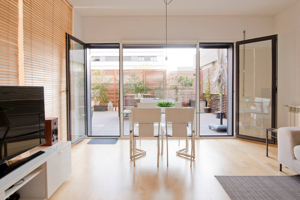 Living room with dinner table for 4 and also one outside