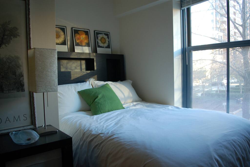 Full size bed with IKEA mattress and feather bed