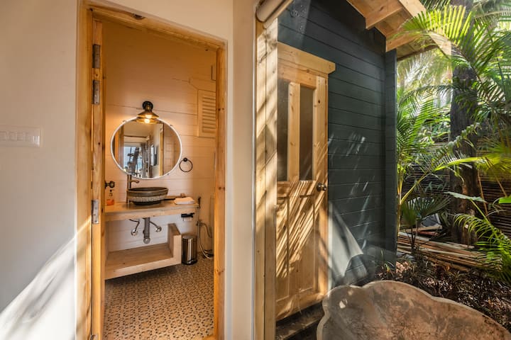The modern ensuite bathroom features 24/7 hot water and complimentary toiletries for your convenience. Clean, spacious, and thoughtfully equipped for a comfortable beachfront getaway