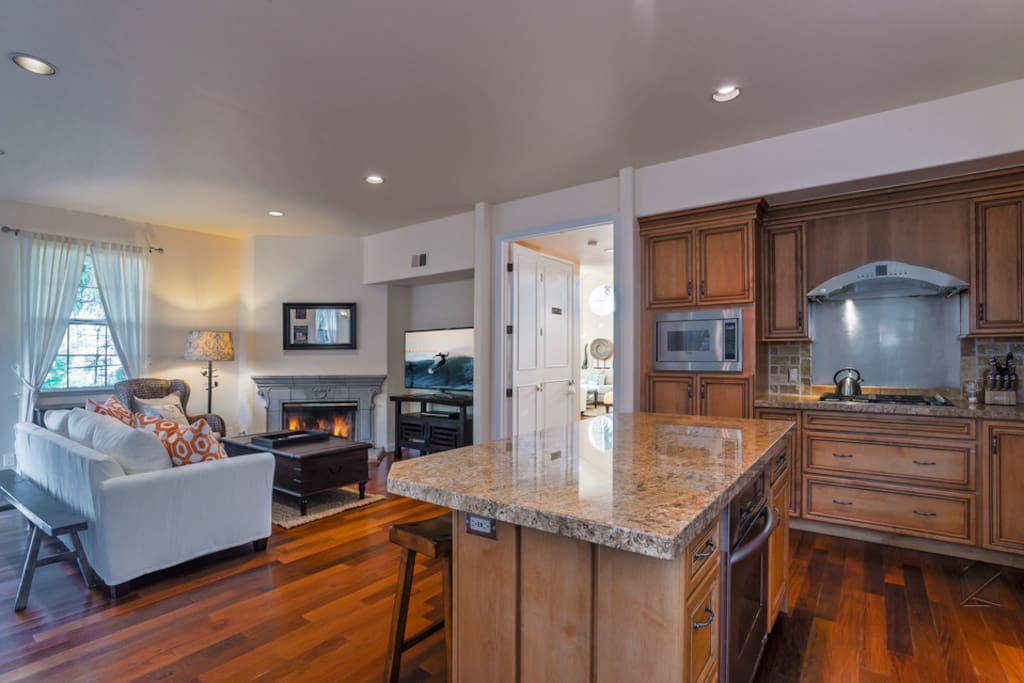 The kitchen island has 3 bar stools at island to complement the round dining table with 4 chairs.