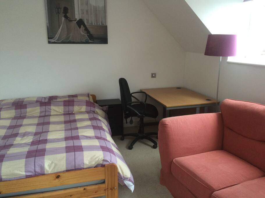 Large desk and chair to work at, and double sofa to relax watching TV