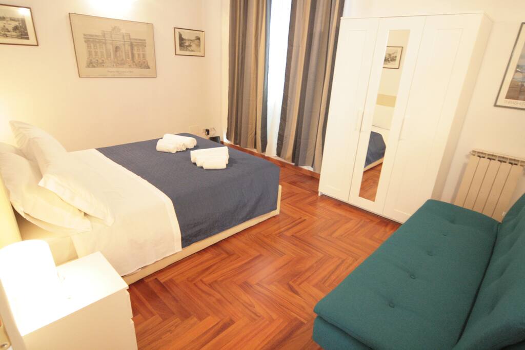 The first room, with french windows air conditioning and painted ceiling