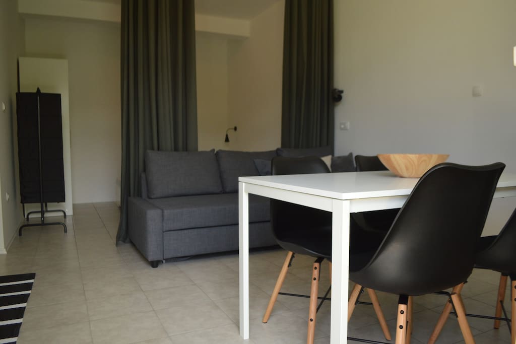 A view of sleeping room and dinning area. This is studio so sleeping area is separated by a curtain