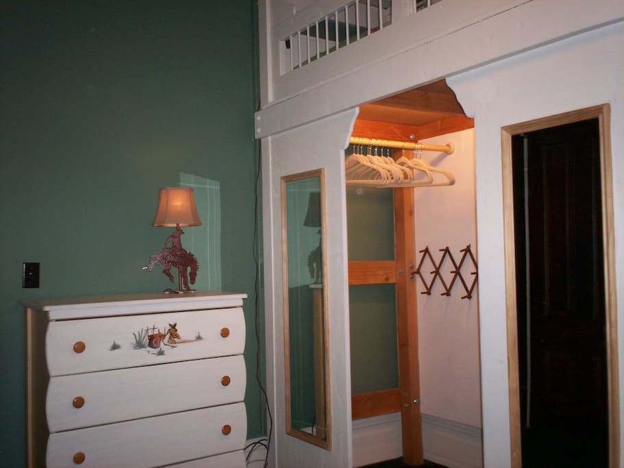Closet and dresser in bedroom