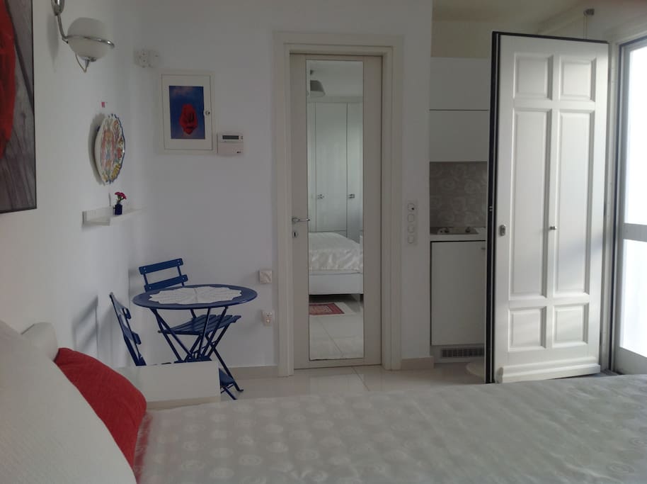 main space with double bed and kitchenette