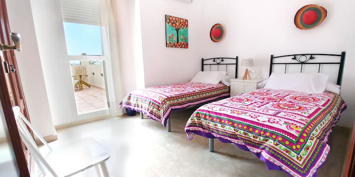 Dormitorio en la primera planta con dos camas individuales, armario, aire acondicionado, calefacción y salida a una gran terraza.