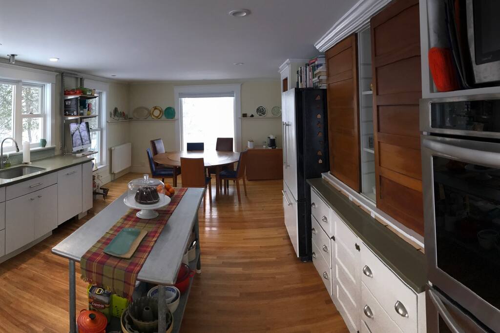 Restaurant prep table island, eat in kitchen, counter depth KitchenAid refrigerator and double KitchenAid wall ovens