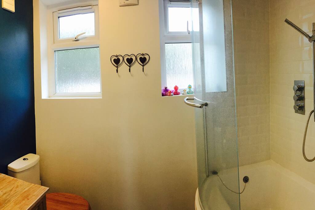 bathroom complete with built in shower and bath