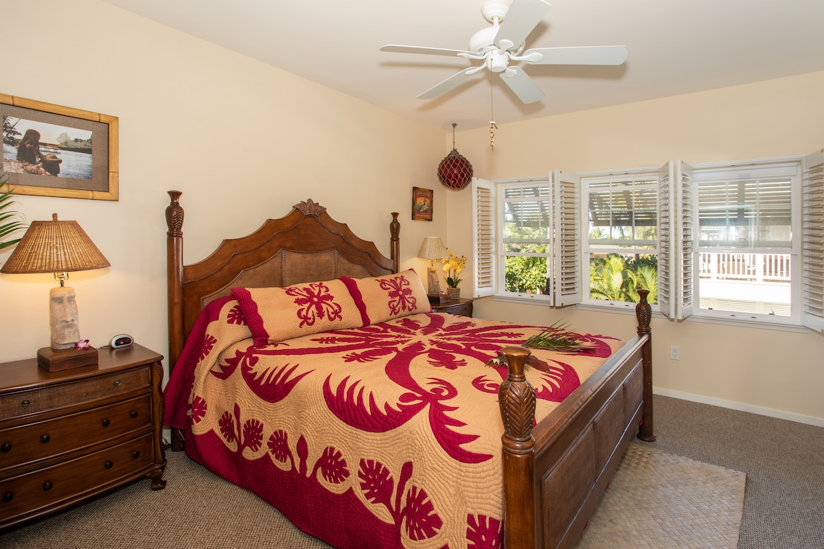 Master bedroom has a California King.  Open the plantation shutters for a nice lush tropical garden view. A separate  door also goes from this suite to the large lanai so you dont have to walk through the bungalow. 