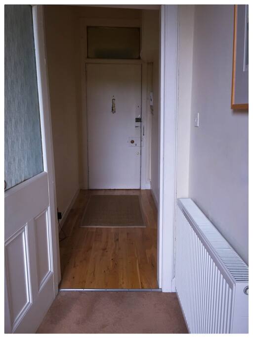 Hallway from bedroom looking to apartment door.