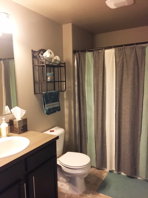 Private bathroom with shower and tub directly next to bedroom