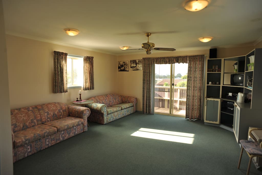 Spacious lounge room leading to balcony .