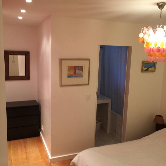 Bedroom leading into bathroom with shower and tub
