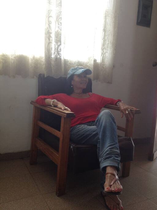 Sala con sillones y TV por cable, mesa y 6 sillas.