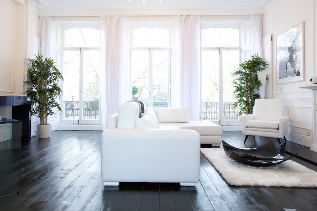 Unusually large living room for a London flat including desk space, large L-shaped sofa and flat screen TV with Freeview channels, Apple TV option and DVD player.