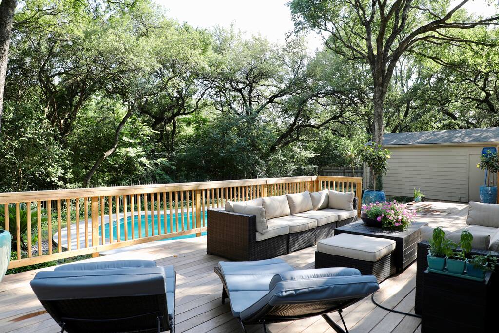Tons of outdoor relaxation space to enjoy the pool and canopy of trees.