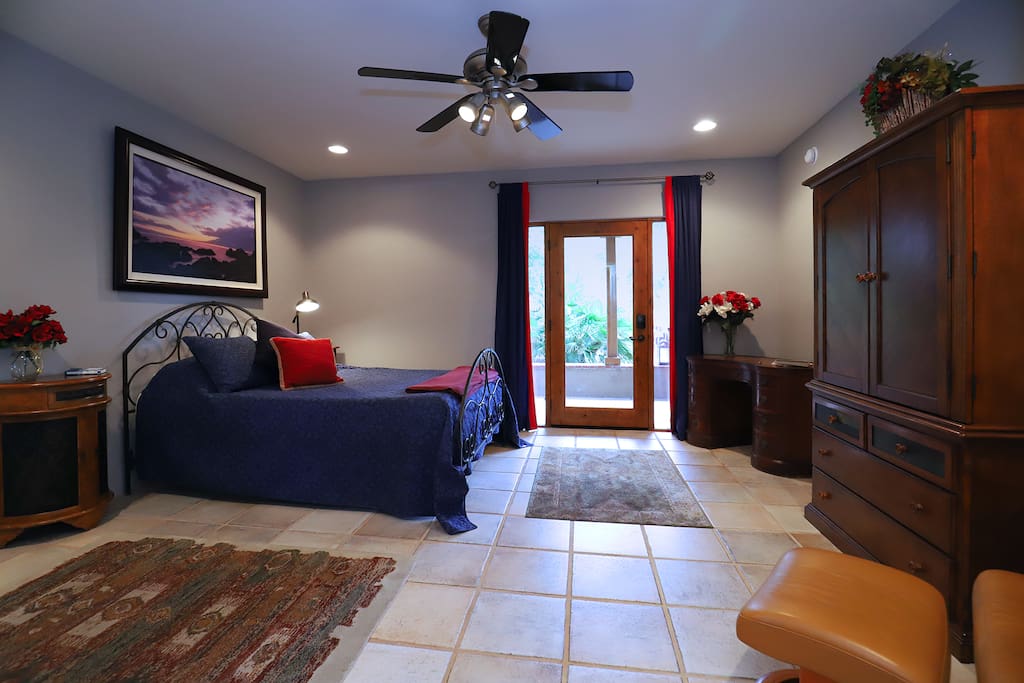 The Blue Room - large bedroom with Queen bed desk, armoire with TV and kitchenette.
