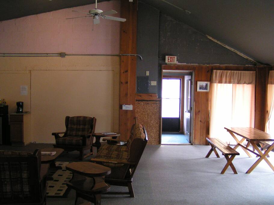 Entrance from front porch with view of picnic table and seating area.