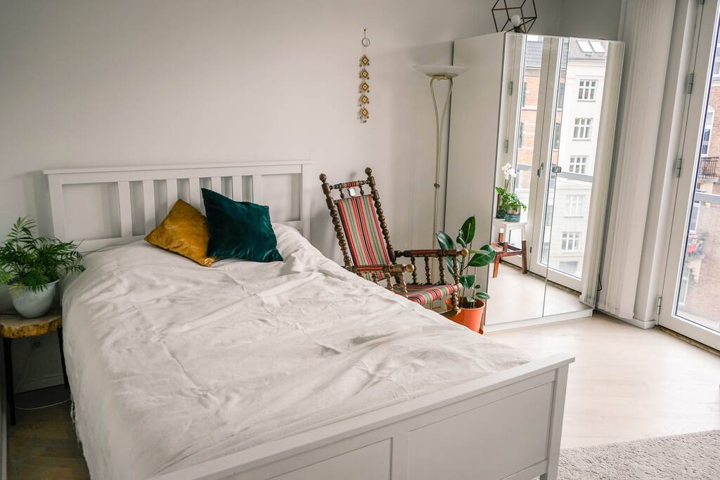 Large bedroom with queen bed and wardrobe