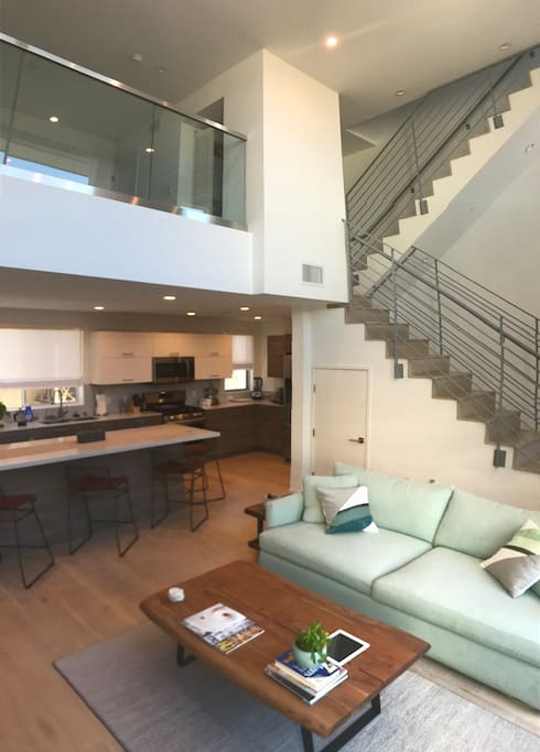 Living room, kitchen, and loft. Two story high ceiling.