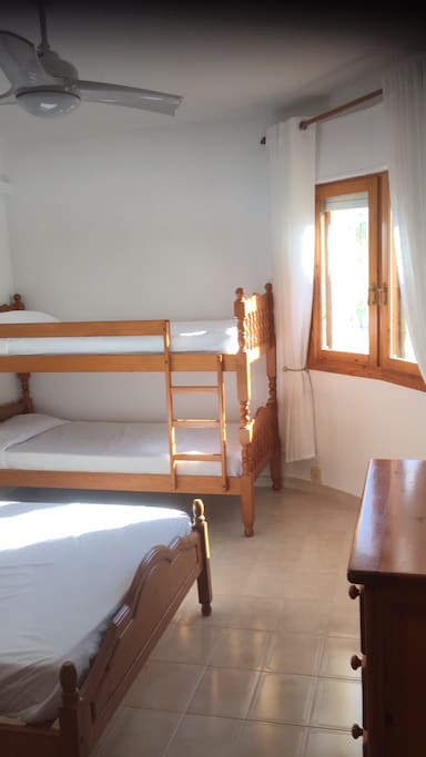 Large bed room with double bed and bunk beds with air conditioning and loads of wardrobe space