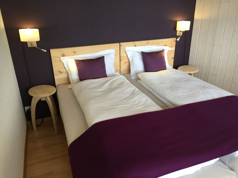 Main bedroom with DORMINO Swiss pine double bed that can be separted into two singles. Natural Pillows and covers.