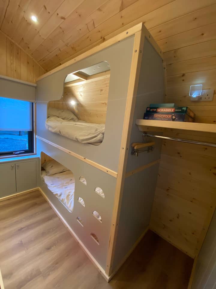 Bunk beds and hanging clothes space. 