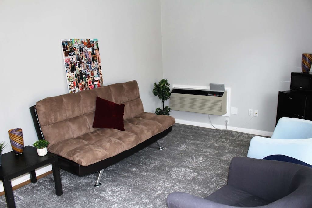 This cozy living room has plenty of seating - and the futon sleep two!