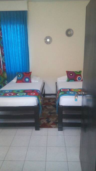 First look as you enter - 2 Twin beds ahead in this self contained air-conditioned room.