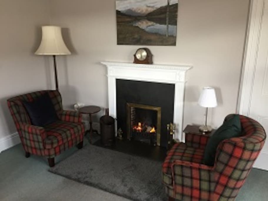 Sitting room with original open fire place for those colder evenings to have a dram of whisky by.