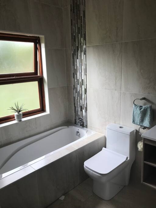 Private newly renovated bathroom with bath