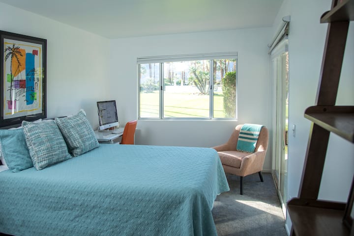 Large guest bedroom with Queen bed, closet, desk.  And printer.  View to pool and sunset on the mountain range