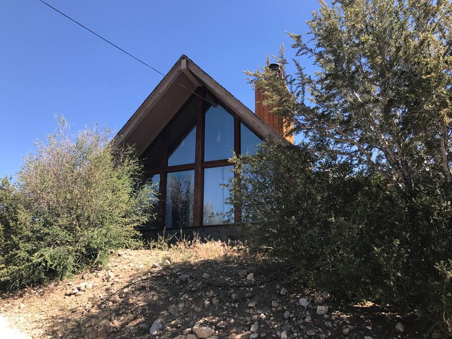 Wall of glass provides panoramic views of the mountains and forest.